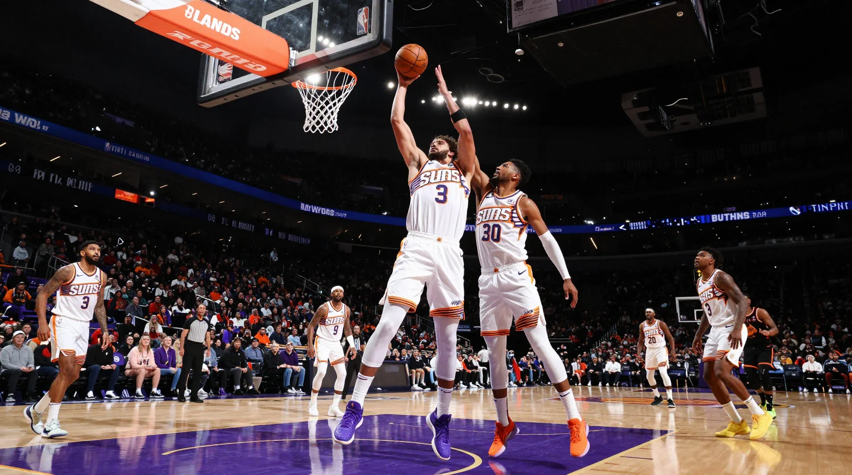 Dramatic NBA basketball scene showing Phoenix Suns competitive intensity