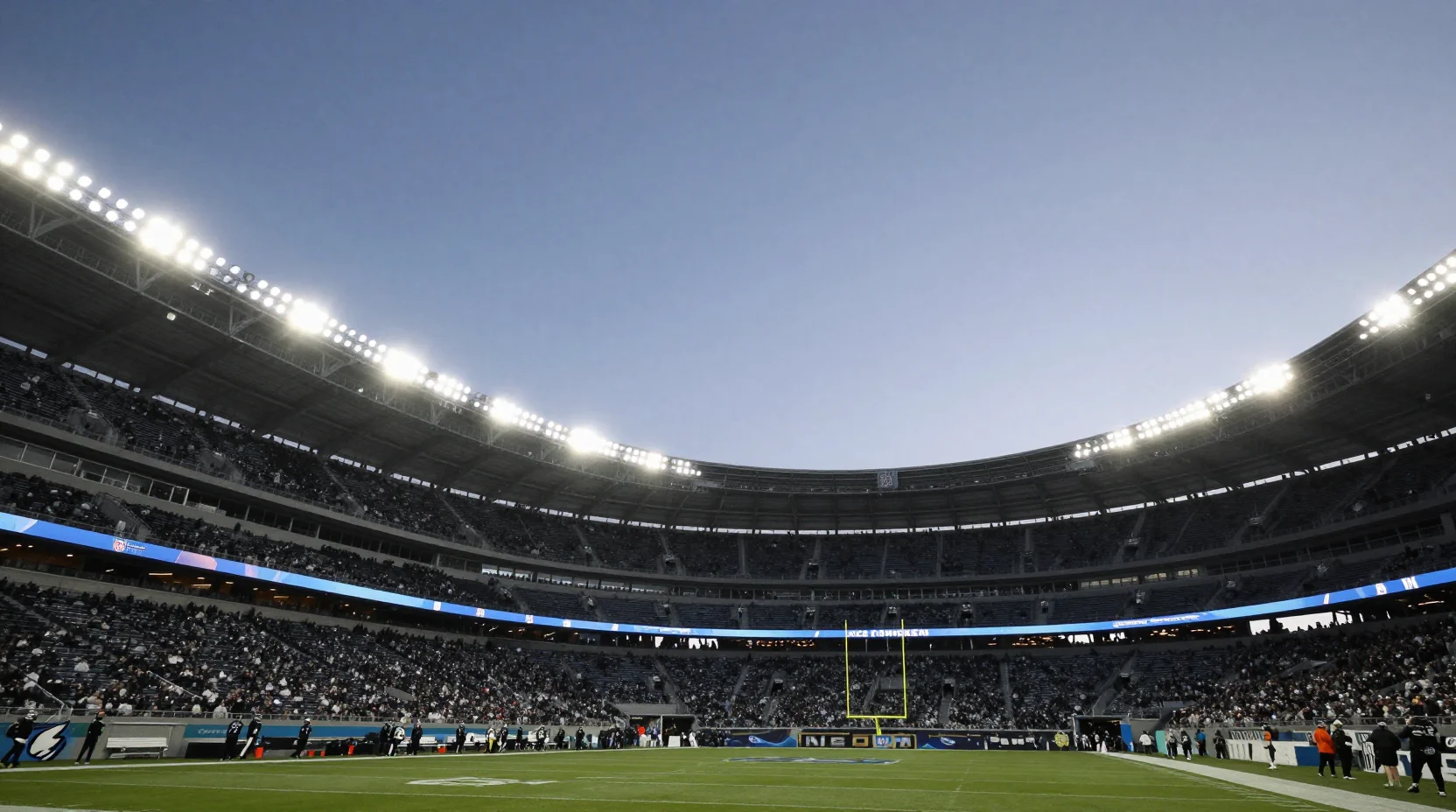 NFL stadium scene with Rams and Seahawks helmets facing off under floodlights