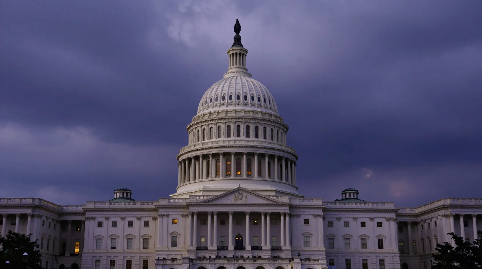 United States Capitol building with dramatic storm clouds at dusk, symbolizing government shutdown tension