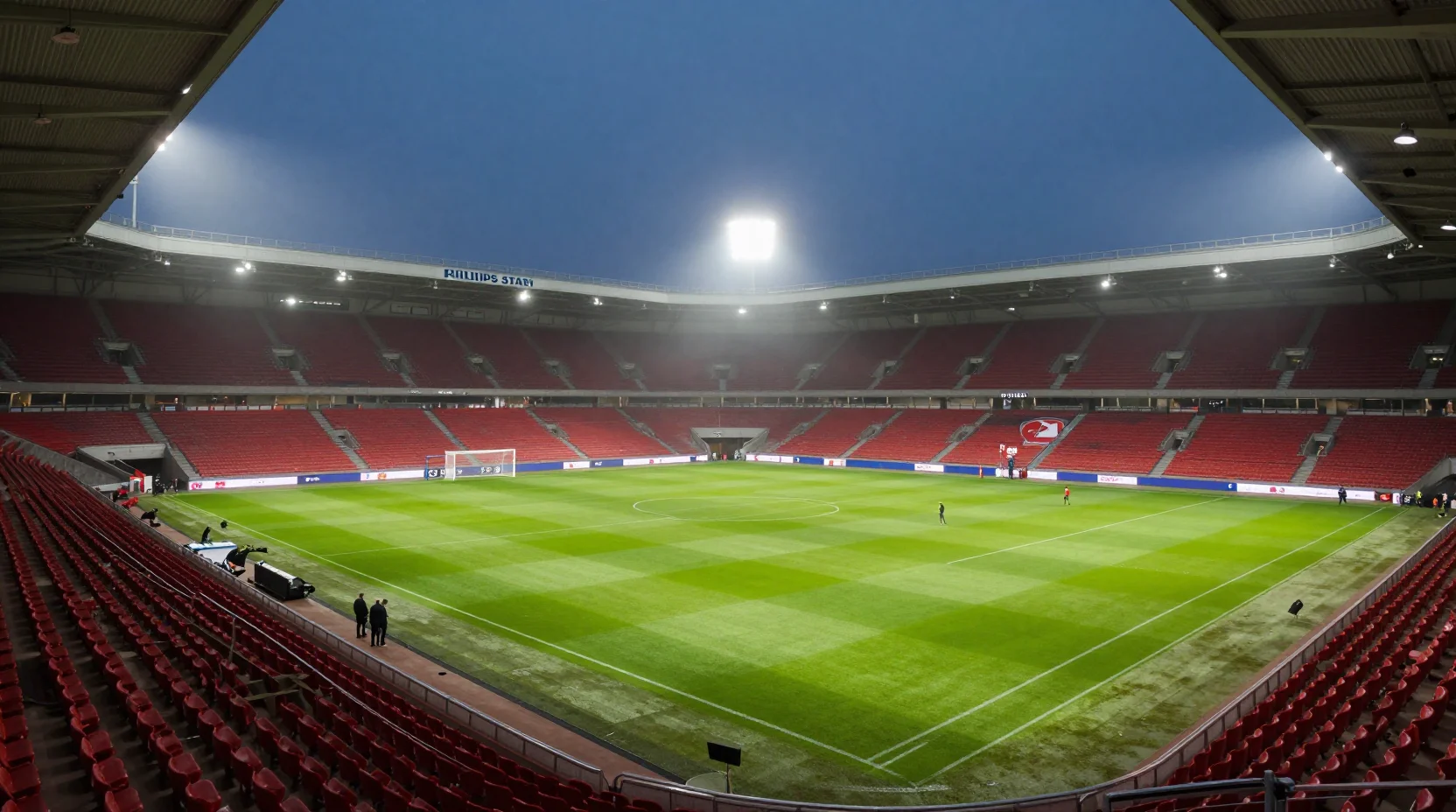 Dramatic night scene at Philips Stadion with passionate PSV supporters