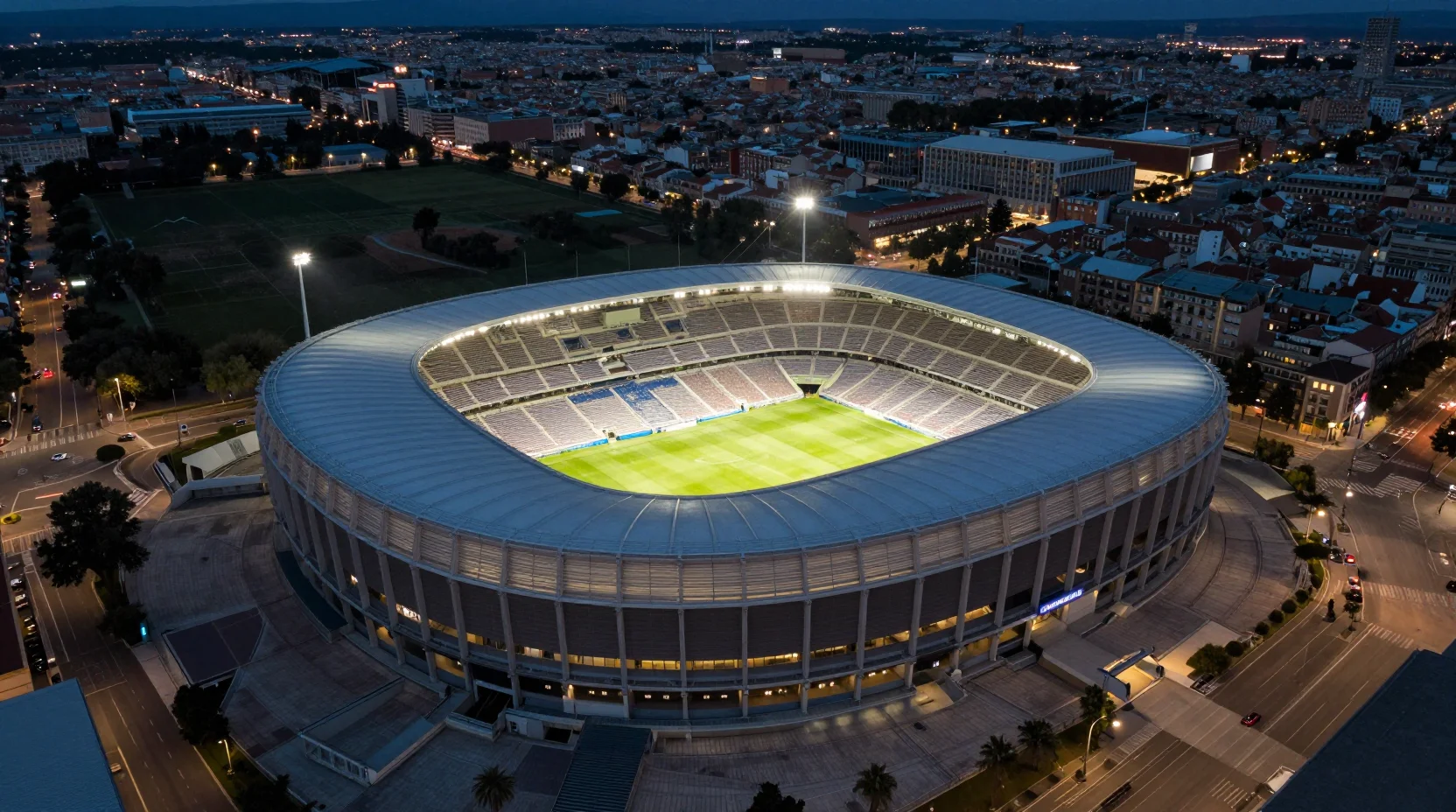 Civitas Metropolitano Stadium aerial view with dramatic evening floodlights